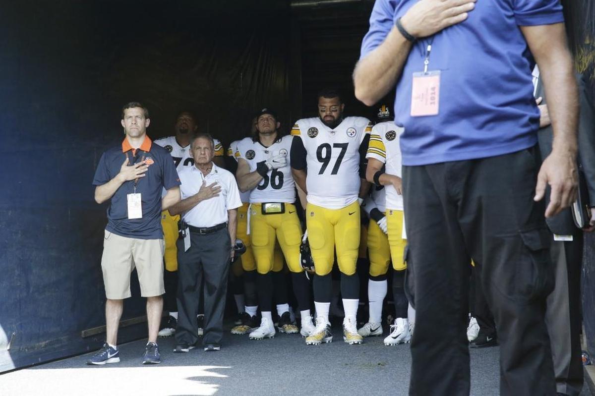 Pittsburgh Steelers players stand in the tunnel during the playing of the national anthem before an NFL game against Chicago Sunday.