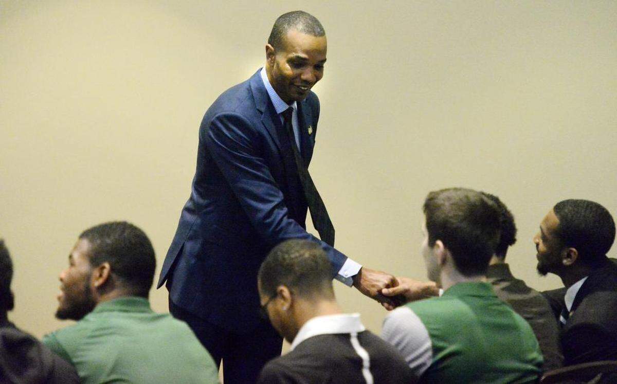 Charlotte 49ers new mens basketball coach Ron Sanchez greets members of the basketball team prior to the start of his introductory news conference Tuesday.