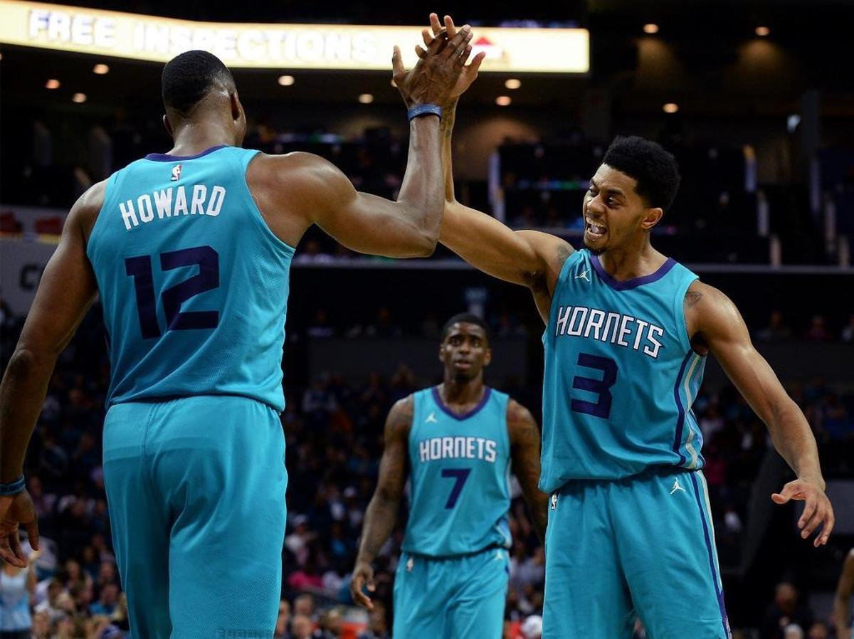Charlotte Hornets center Dwight Howard, left, is congratulated by forward Jeremy Lamb, right, after Howard dunked against Atlanta Friday. The Hornets defeated the Hawks 109-91.