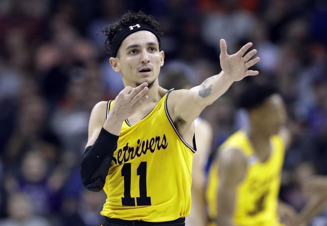 UMBC's K.J. Maura (11) celebrates after a basket against Virginia during the first half of Friday’s first-round game in the NCAA men's college basketball tournament at Spectrum Center.