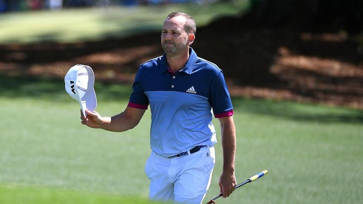 Sergio Garcia tips his cap to the gallery as he approaches the 18th green Friday at the Masters. Garcia, playing his 70th consecutive major and still looking for that first victory, shot a 3-under-par 69 to join three others for a share of first place.
