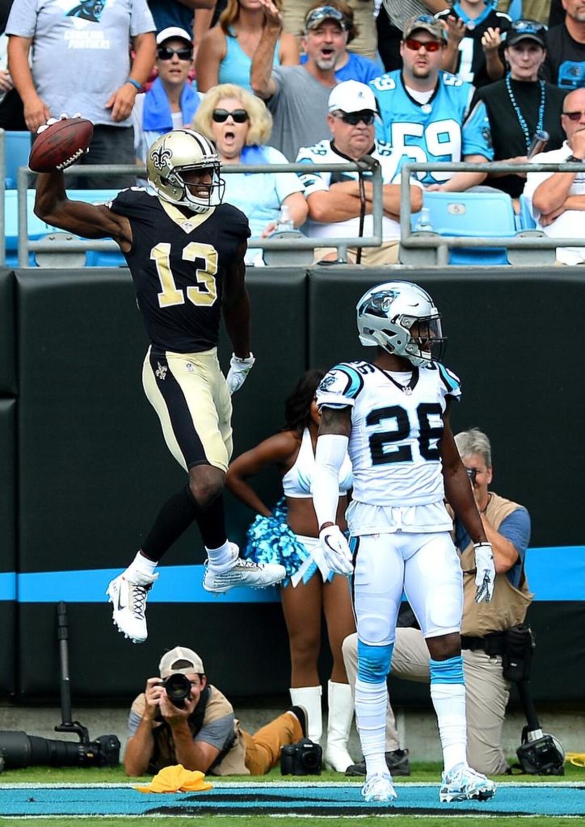 New Orleans Saints wide receiver Michael Thomas scores against the Panthers in September of 2017 as Carolina Panthers defensive back Daryl Worley (26) tries to ignore the celebration.
