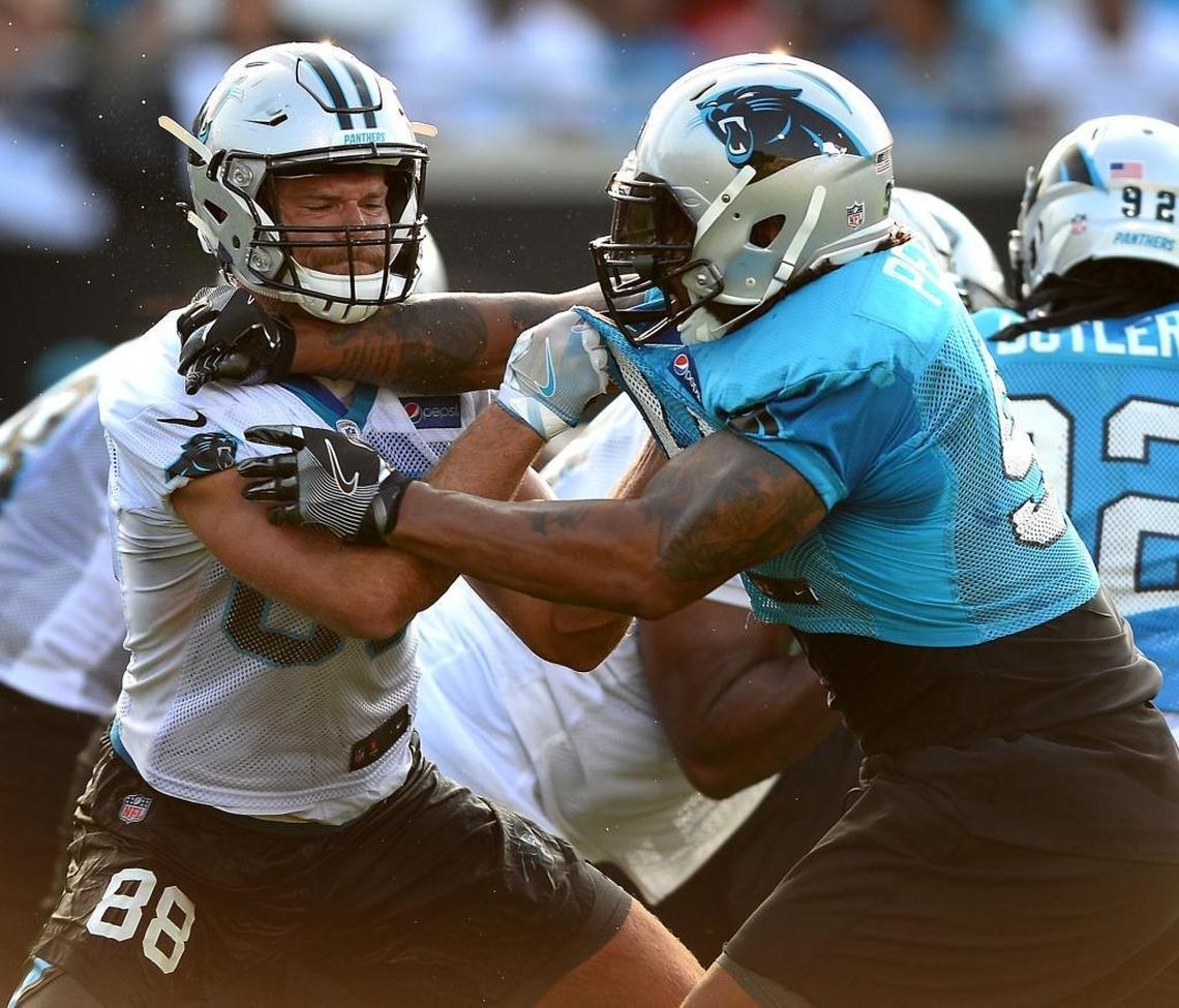 Carolina Panthers tight end Greg Olsen, left, backed out of a drill with Julius Peppers before one practice started but wasn’t able to get out of this one.