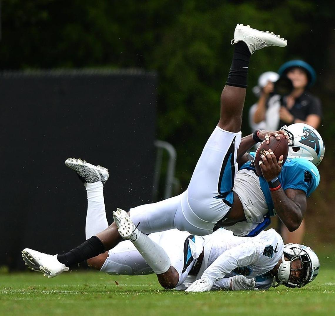 Carolina Panthers safety L.J. McCray fights to maintain control of the football after a mid-air collision with wide receiver Damiere Byrd during Thursday’s training-camp practice. McCray was briefly shaken up on the play but returned to the workout a few minutes later.