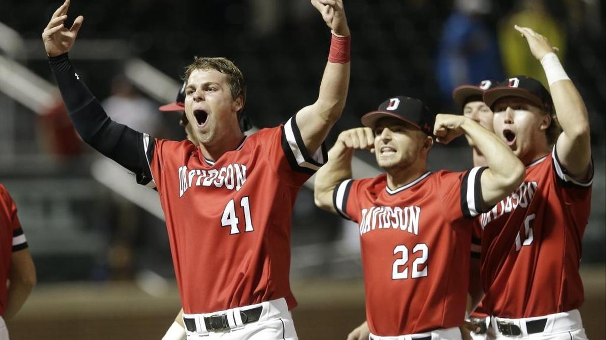 Davidson's Will Robertson (41) celebrates with teammates after Davidson defeated North Carolina 2-1 in an NCAA college baseball tournament regional game in Chapel Hill Sunday.