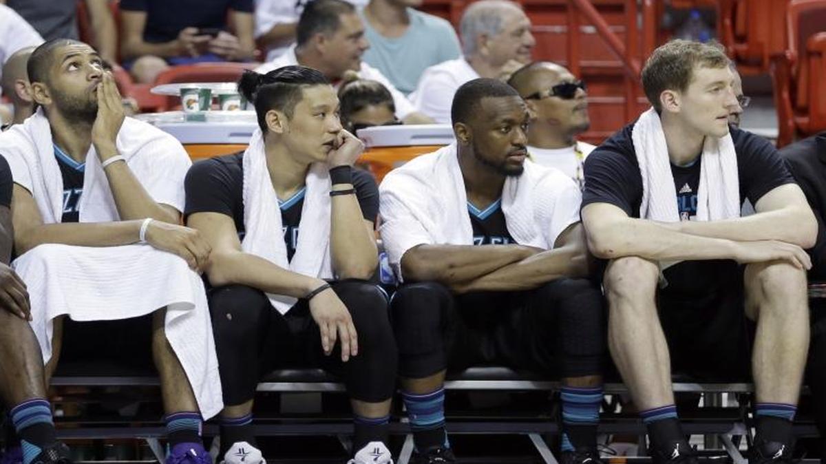 Charlotte Hornets players on the bench watch the final minute of the second half in Game 7 of their first-round NBA playoff series against the Miami Heat on Sunday. Miami won the game 106-73 and advances to the Eastern Conference semifinals.