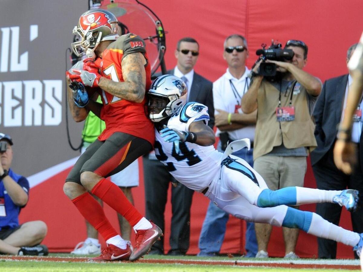 Carolina Panthers cornerback James Bradberry (24) tries to dislodge the ball from Tampa Bay Buccaneers wide receiver Mike Evans (13) in a 2017 game. Bradberry and Evans respect each other enough that they once exchanged jerseys after a game.