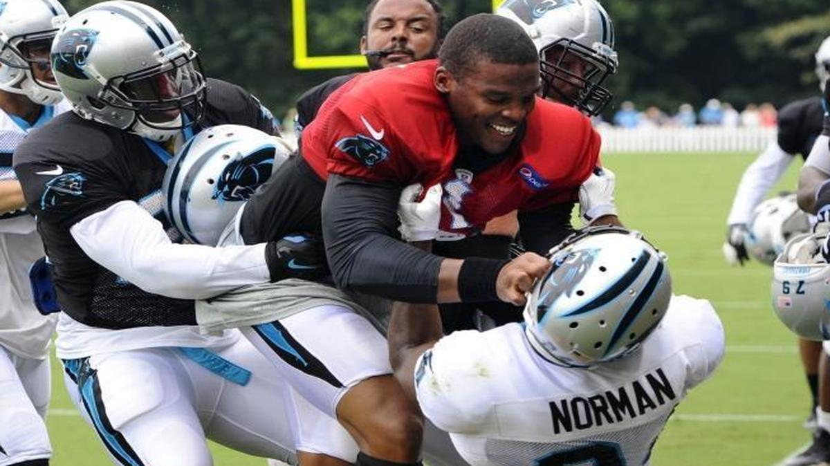 Josh Norman (24) now says of his 2015 training-camp scuffle with Cam Newton and this picture: “He had a piece of me, and I tried to sling him. I tried to hip-toss him. And they got that picture of him smiling and he’s got me clutched up – of all pictures to get!”