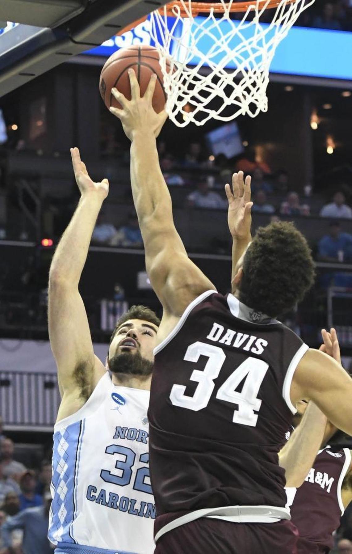 North Carolina Tar Heels forward Luke Maye (32) has his shot blocked by Texas A&M Aggies center Tyler Davis (34) in the second half during the second round of the NCAA tournament at the Spectrum Center in Charlotte on Sunday. Texas A&M won 86-65.