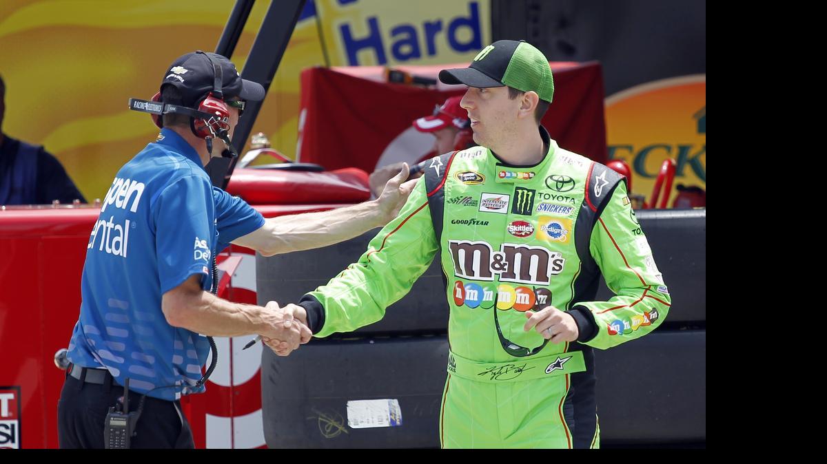 
Kyle Busch, right, gets a handshake while walking to his car to practice for Saturday's NASCAR Sprint All-Star Race ub Concord on Friday. Busch is back for the first time since breaking his right leg and left foot in a Feb. 21 crash.
