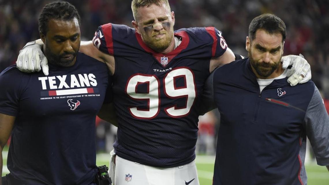 Houston Texans defensive end J.J. Watt (99) is helped off the field after an injury that ended his season on Sunday. The league is less in his absence.