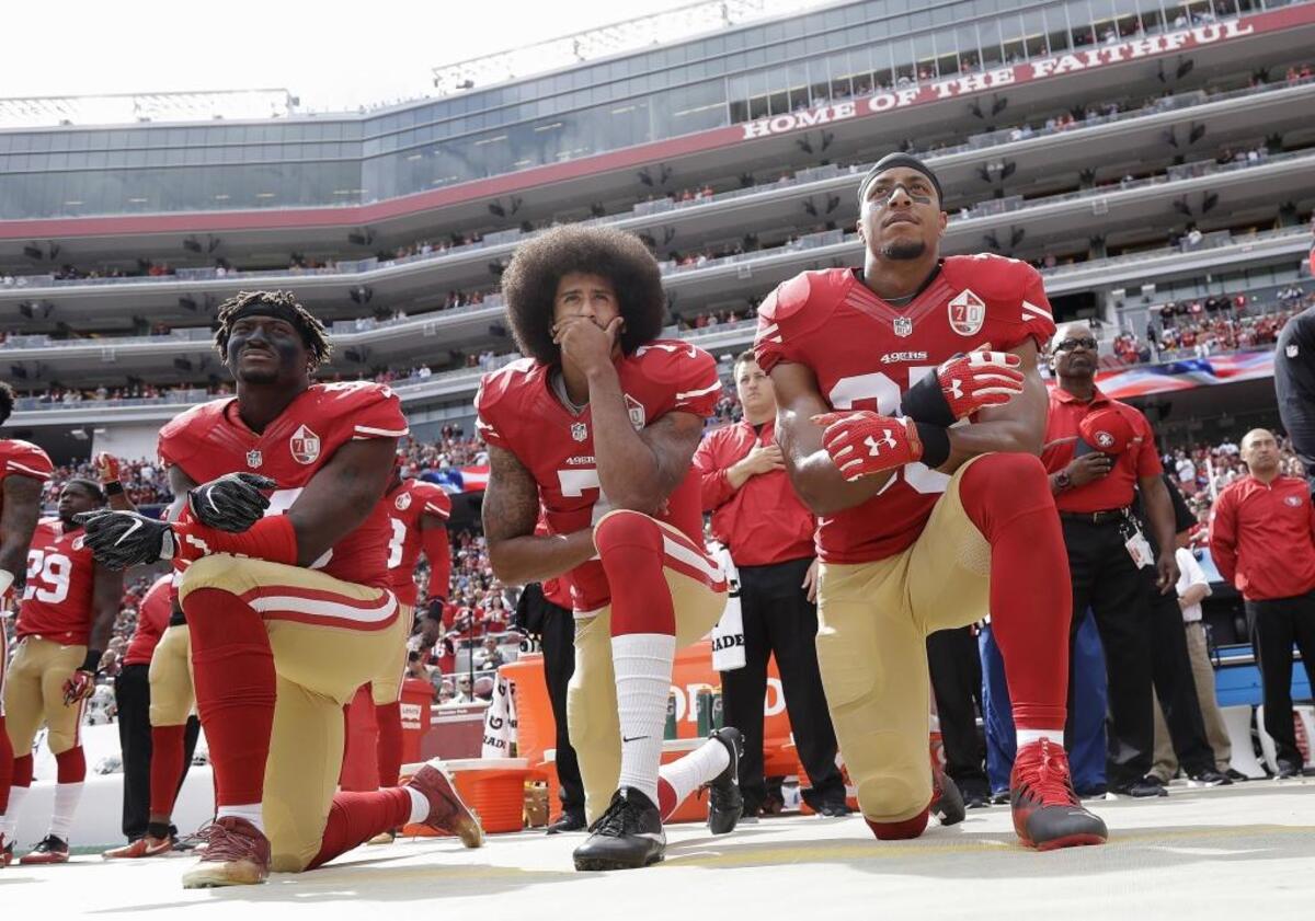 Former San Francisco 49ers quarterback Colin Kaepernick (center) hasn’t signed with another NFL team, apparently blackballed by the league for his national anthem protests. Can it last all season – or forever?