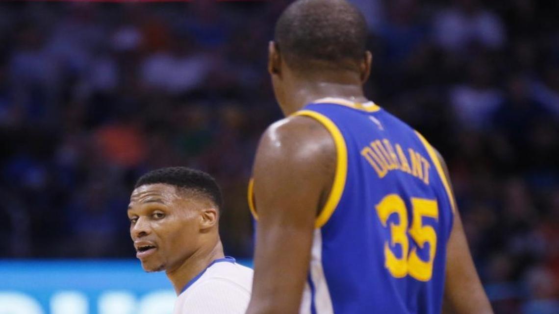 Oklahoma City Thunder guard Russell Westbrook, left, comments to Golden State Warriors forward Kevin Durant (35) as they walk off the court on Saturday.