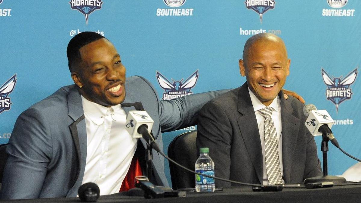 Charlotte Hornets center Dwight Howard jokes with general Manager Rich Cho during a news conference in June.