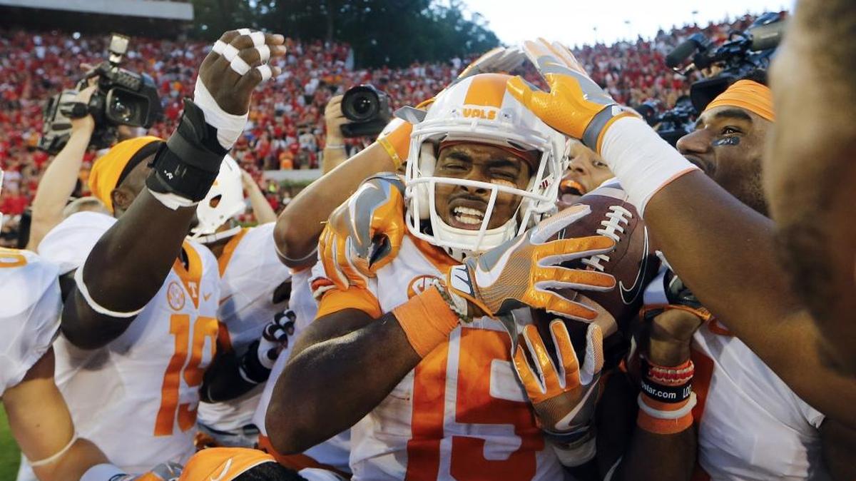 Tennessee wide receiver Jauan Jennings (15) is mobbed by his teammates after making a game-winning catch as time expired against Georgia in Athens, Ga. Tennessee won 34-31.
