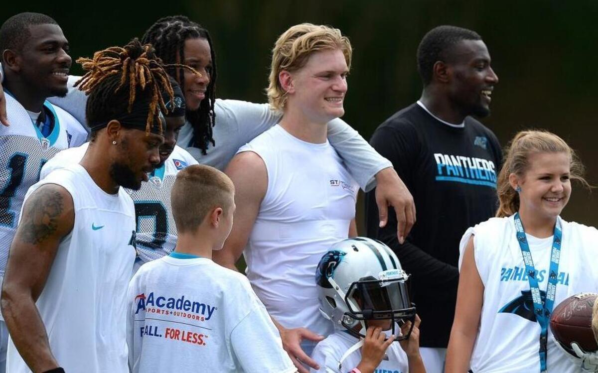 Carolina Panthers wide receiver Brenton Bersin, center, poses with teammates at training camp in Wofford. Every season, some fans expect the camp to be his last.