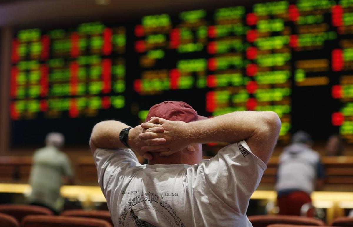 A man watches a baseball game in the sports book in a Las Vegas hotel. The Supreme Court in 2018 gave its go-ahead for states to allow gambling on sports across the nation, striking down a federal law that barred betting on football, basketball, baseball and other sports in most states.