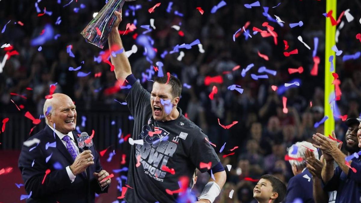 New England Patriots quarterback Tom Brady (12) has five Super Bowl titles, but does that move him past Joe Montana as the best NFL quarterback ever?