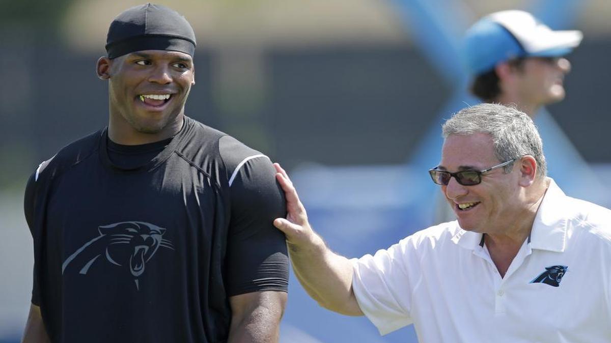 
Carolina Panthers quarterback Cam Newton (left, with GM Dave Gettleman) went to Australia to take part in an Australian Rules Football event, and some fans questioned his commitment.
