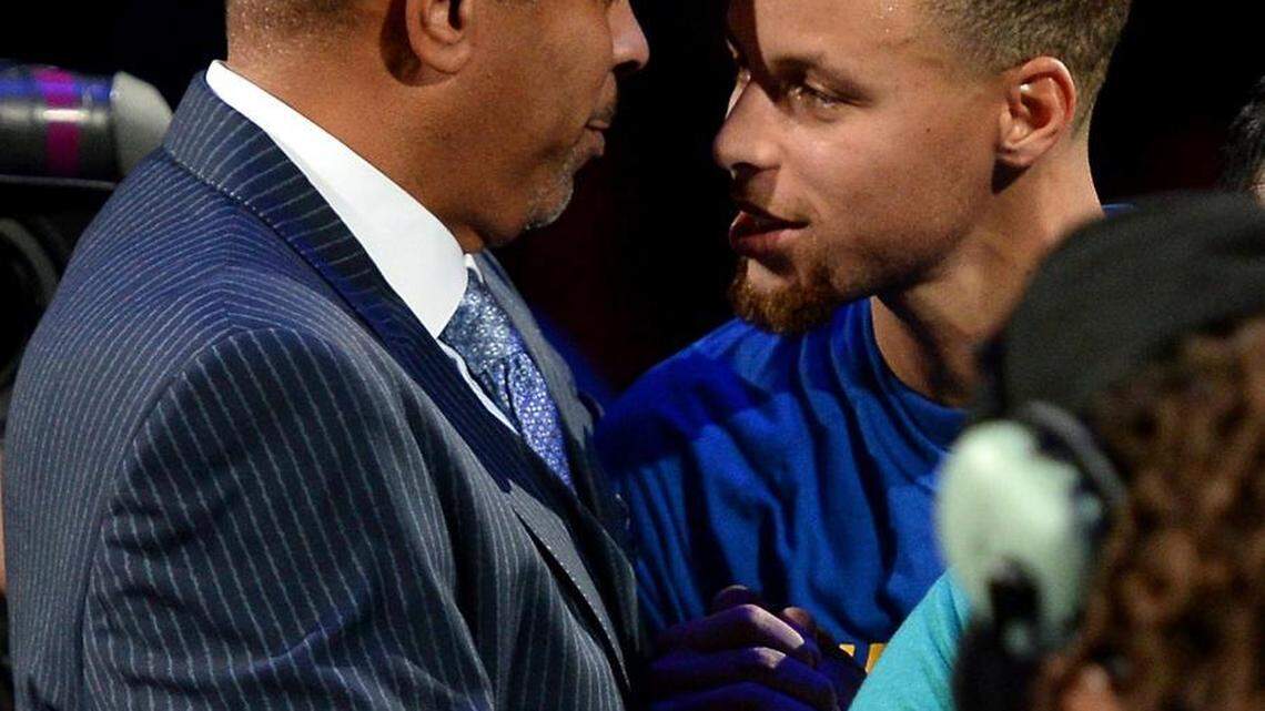 Golden State Warriors guard Stephen Curry, right, embraces his father, Dell Curry following a ceremony recognizing Dell Curry's contributions to the Charlotte Hornets franchise at Time Warner Cable Arena in Charlotte, on Wednesday.