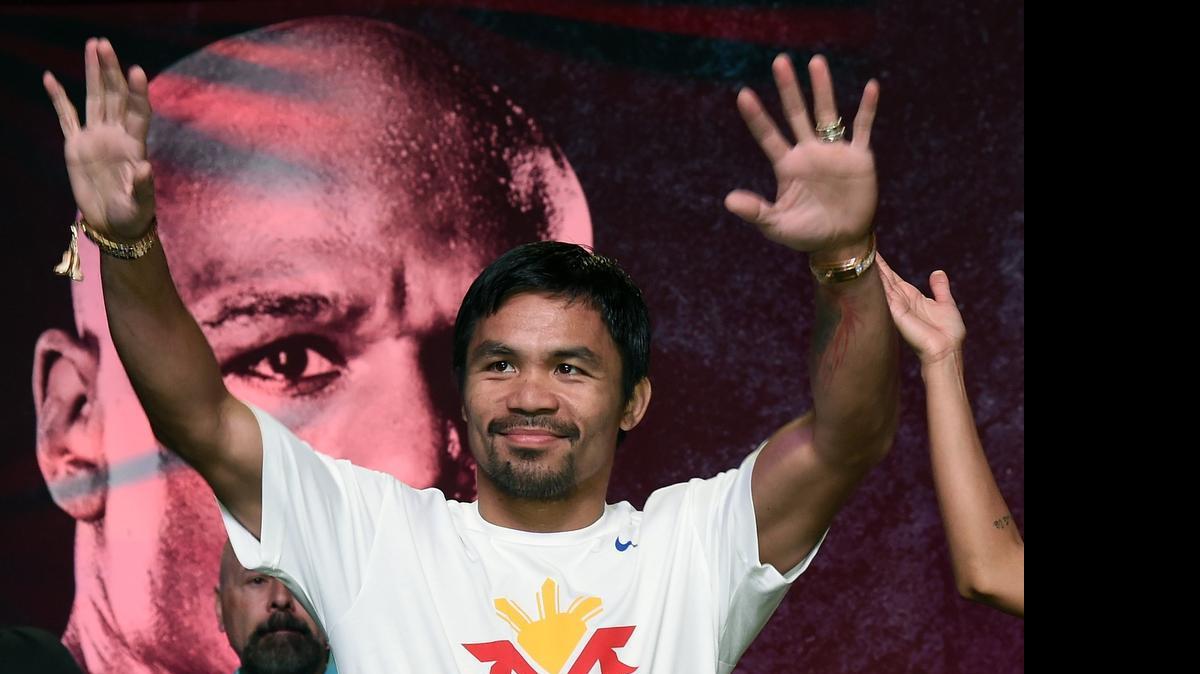 
WBO welterweight champion Manny Pacquiao arrives at a fan rally Tuesday at the Mandalay Bay Convention Center in Las Vegas, Nevada. Pacquiao will face WBC/WBA welterweight champion Floyd Mayweather Jr. in a unification bout.
