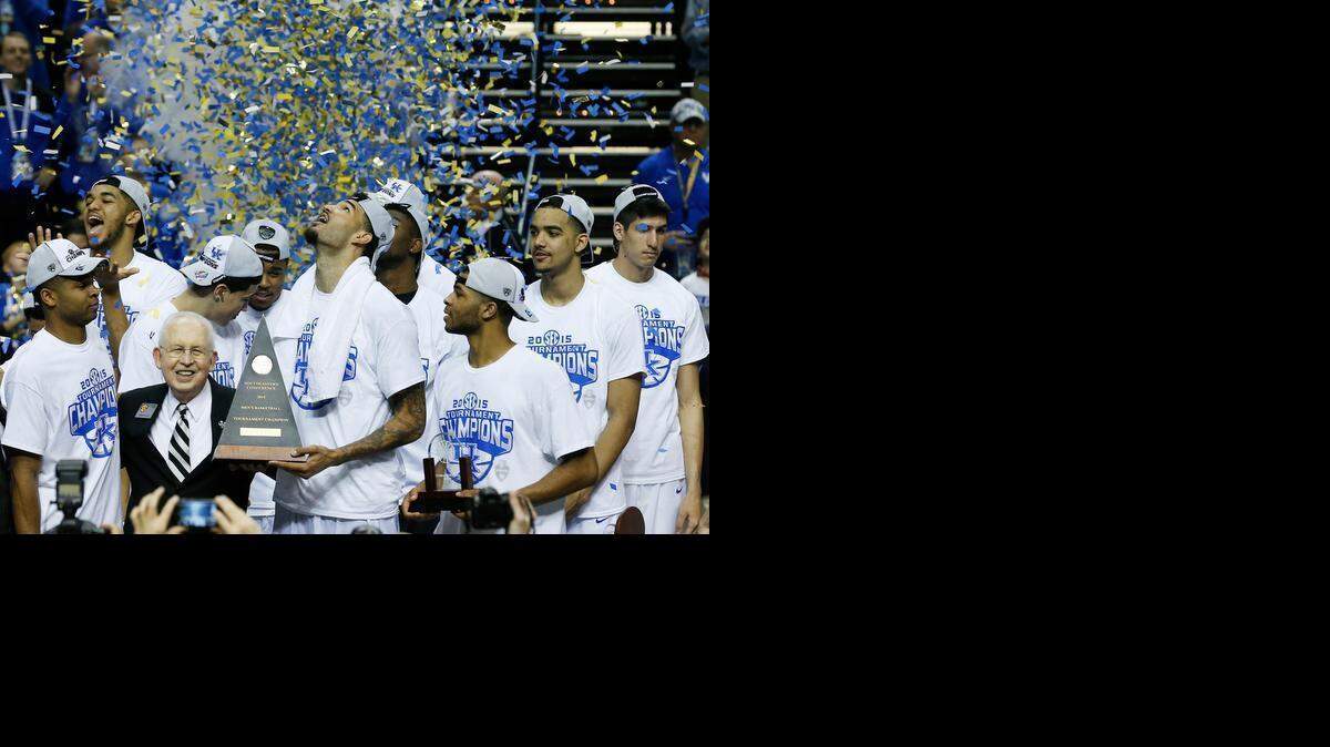 
Kentucky forward Willie Cauley-Stein holds the trophy after the NCAA college basketball Southeastern Conference tournament championship game against Arkansas, Sunday, March 15, 2015, in Nashville, Tenn. Kentucky won 78-63. 

