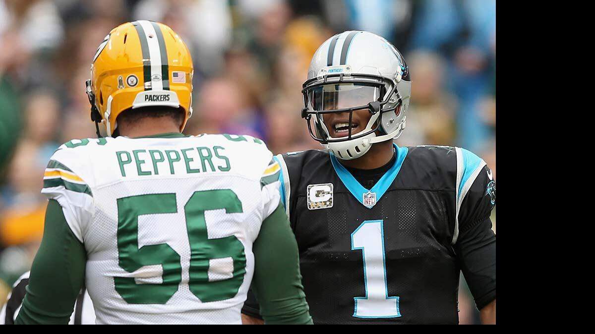 NOVEMBER 08: Cam Newton #1 of the Carolina Panthers talks to Julius Peppers #56 of the Green Bay Packers in the 1st half during their game at Bank of America Stadium on November 8, 2015 in Charlotte, North Carolina. (Photo by Streeter Lecka/Getty Images)