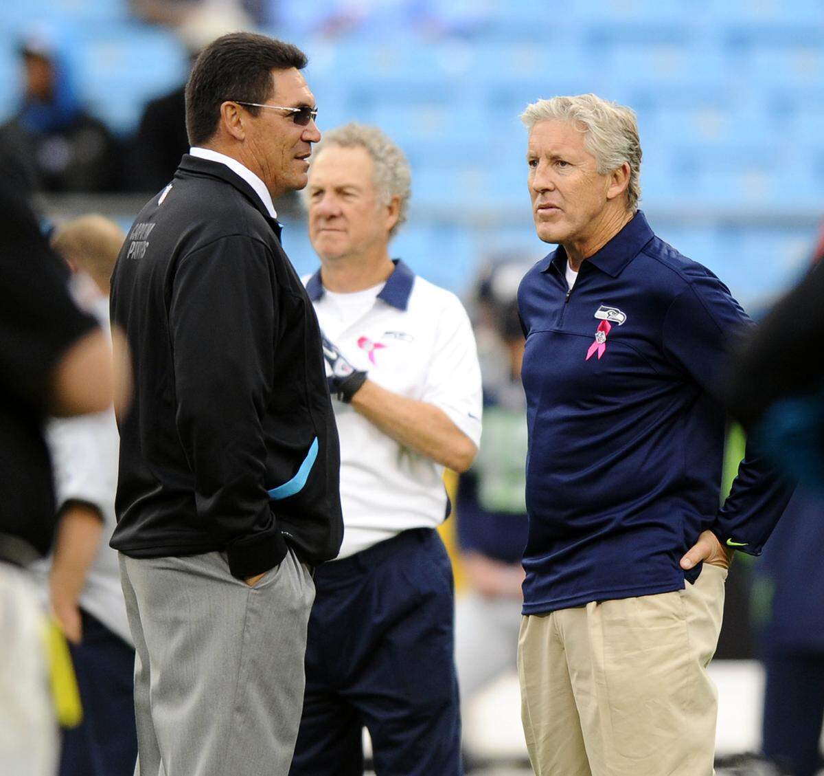 Carolina Panthers head coach Ron Rivera and Seattle Seahawks head coach Pete Carroll talk at midfield during warmups prior to playing a 2012 game at Bank of America Stadium.