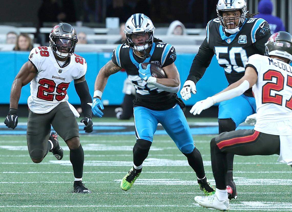 Carolina Panthers running back Jonathon Brooks, center, rushes for yardage as the Tampa Bay Buccaneers defense gives chase during action on Dec. 1, 2024, at Bank of America Stadium.