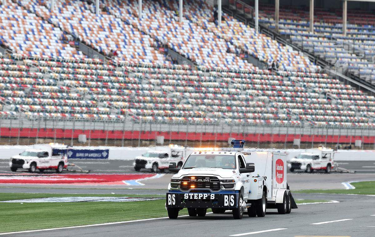 Dryer trucks work on the track and pit road at Charlotte Motor Speedway in Concord, NC on Saturday, May 23, 2026. The rain has canceled the NASCAR Cup Series practice and qualifying for the day.