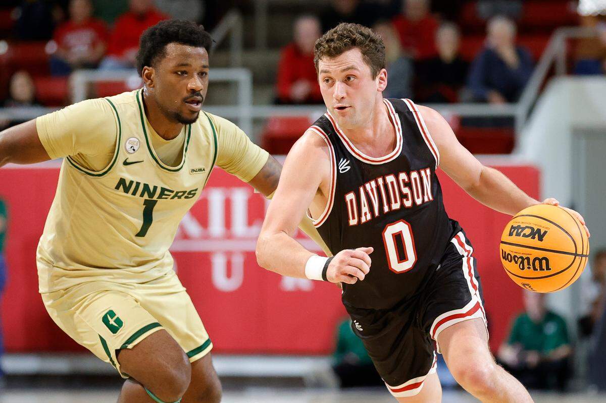 Davidson guard Foster Loyer, dribbling around Charlotte guard Montre’ Gipson, during an game this season, leads the Wildcast into the Atlantic 10 tournament this week.