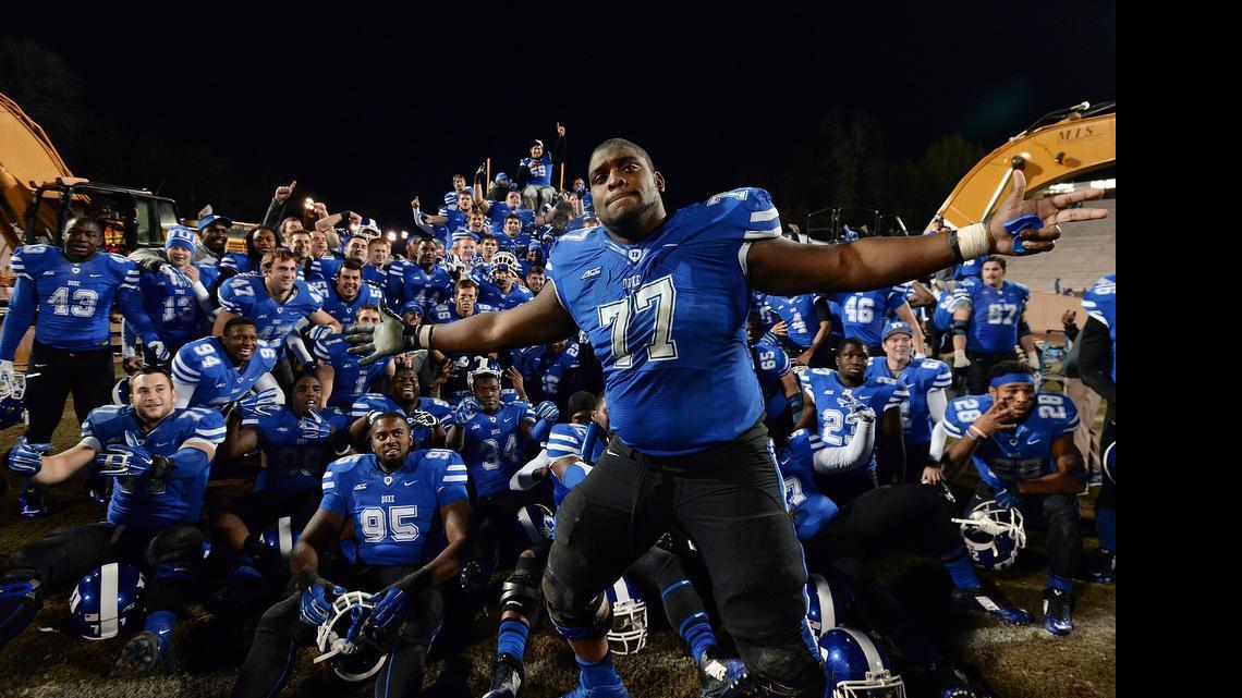 
ACC commissioner John Swofford expects to announce league athletic events overseas in “the reasonably near future” - a football game in Europe to start a season is a likely candidate for early action. Above, Duke guard Laken Tomlinson (77) photo bombs a group shot as the Blue Devil football team poses with heavy equipment prior to a groundbreaking ceremony after Duke beat Wake Forest 41-21 at Wallace Wade Stadium, Nov. 29, 2014 in Durham. 

