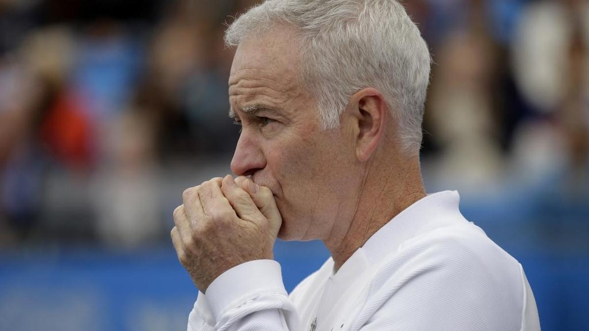 FILE - In a Saturday June 18, 2016 file photo, John McEnroe, Coach to Canada's Milos Raconic, looks across the court as Raconic plays Australia's Bernard Tomic during their semifinal tennis match on the sixth day of the Queen's Championships London. McEnroe wants to see players get fed up that they can't break through against Roger Federer and Rafael Nadal, that they remain stuck behind Novak Djokovic and Andy Murray heading into Wimbledon.(AP Photo/Tim Ireland, File)