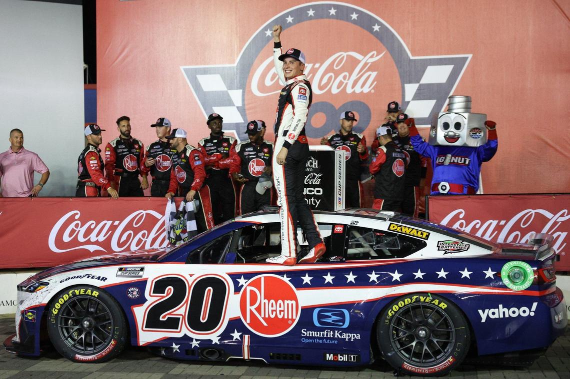 Christopher Bell stands on his No. 20 car after winning the Coca-Cola 600 on Sunday night at Charlotte Motor Speedway.
