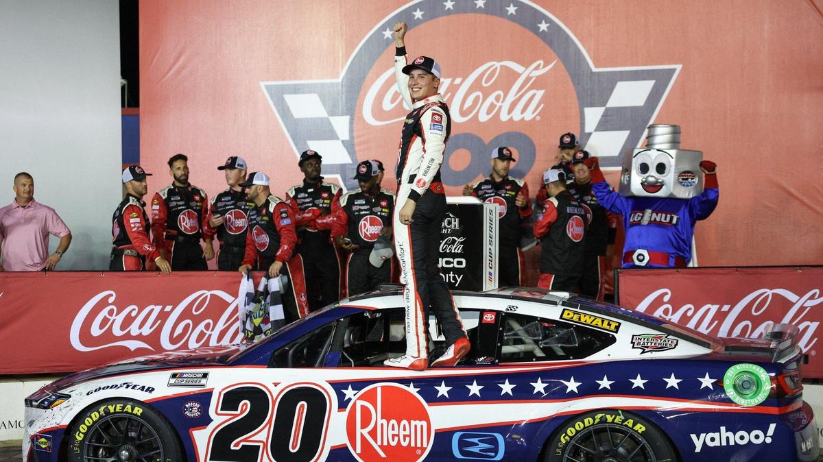 Christopher Bell stands on his No. 20 car after winning the Coca-Cola 600 on Sunday night at Charlotte Motor Speedway.