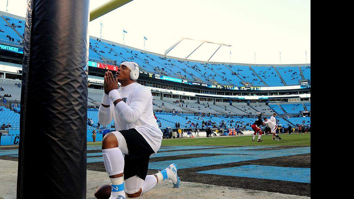 Carolina Panthers quarterback Cam Newton prays at a goal post at Bank of America Stadium before the start of the NFC Championship game on Sunday, Jan. 24, 2016. The Panthers hosted the Arizona Cardinals.