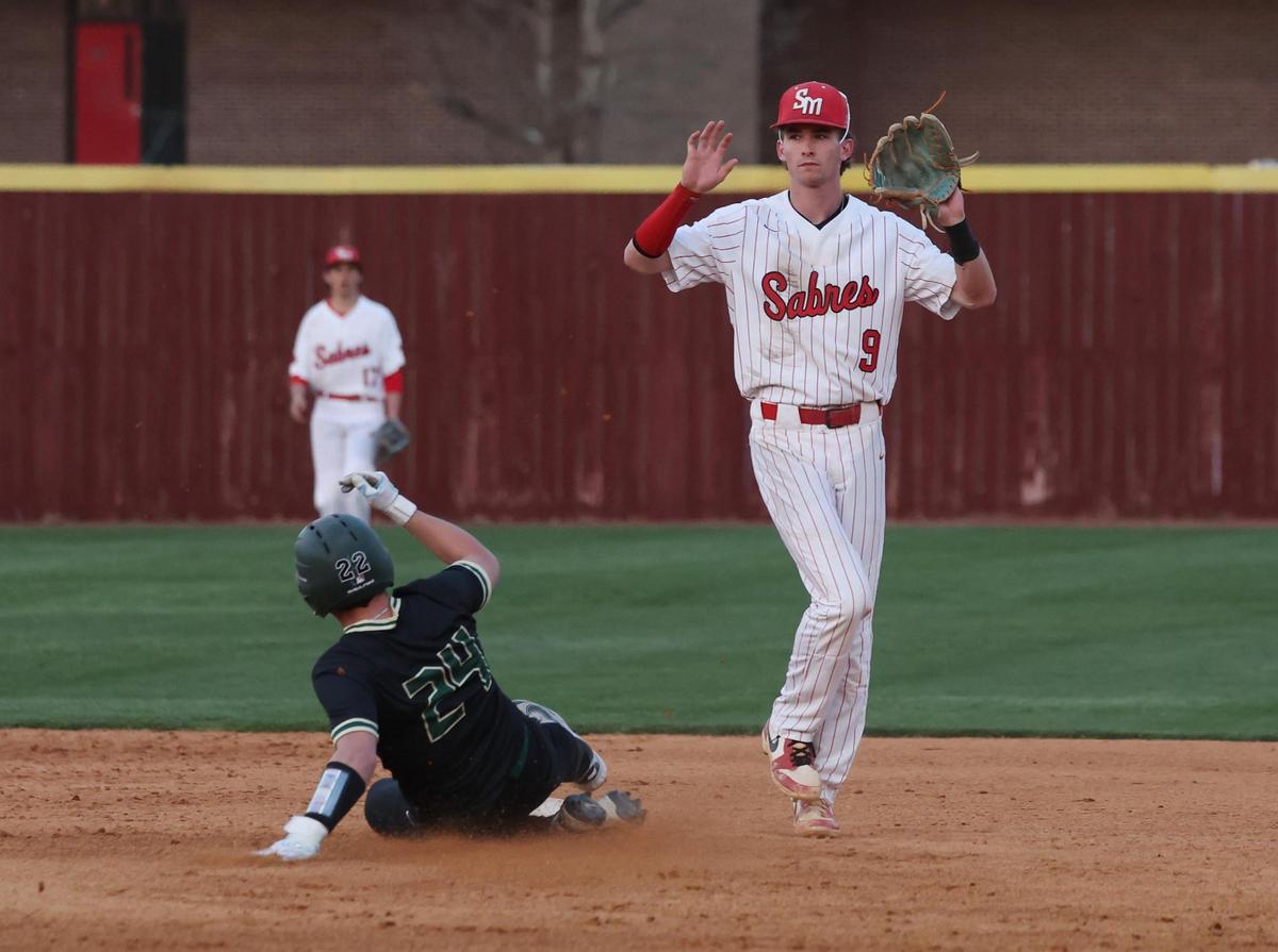 Catawba Ridge’s Ashton Mayo slides back into second base as South Meck’s Chris Short waits for the ball Wednesday in Charlotte.