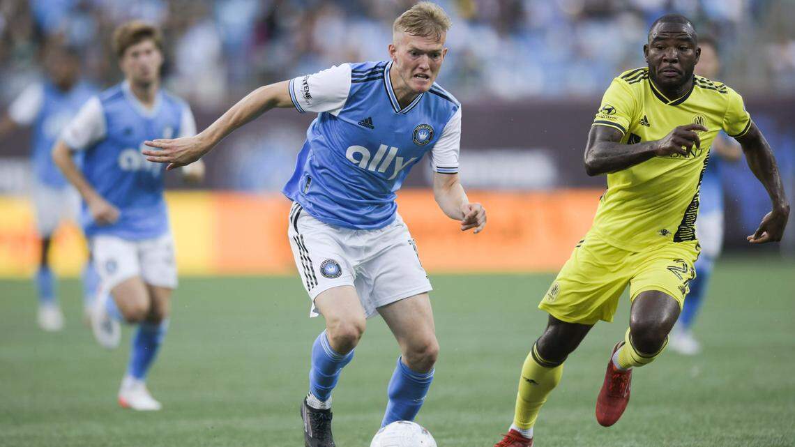 Charlotte FC forward Karol Swiderski (11) jockeys for control of the ball over Nashville SC midfielder Brian Anunga (27) during the first half of a match at Bank of America Stadium in Charlotte, N.C., Saturday, July 9, 2022.