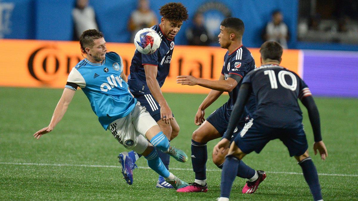 Charlotte’s #13, Brandt Bronico battles three New England Revolution players in the season opener at Bank of America Stadium during a Saturday evening game on Feb. 25, 2023. Charlotte FC lost to New England on a late second half goal 1-0.