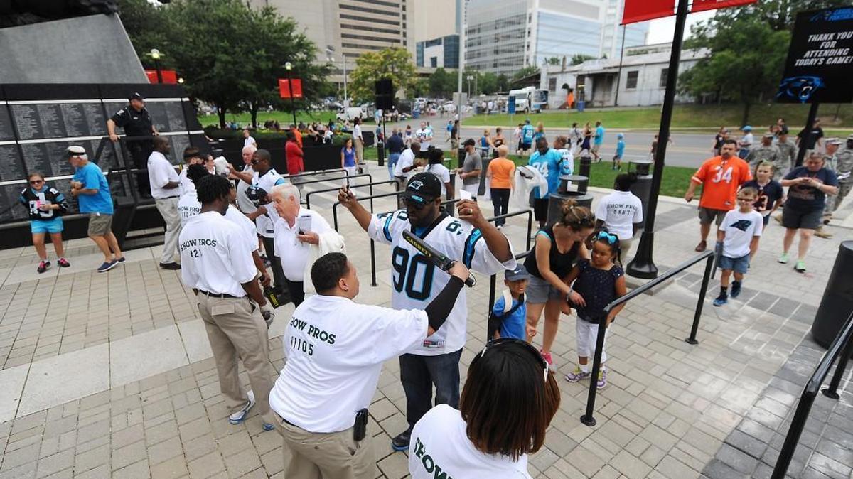 Event staff employees scan fans as they enter Bank of America Stadium prior to a Carolina Panthers preseason game against the Chicago Bears in August 2013. The ACC announced Friday that security measures for the 2015 ACC Championship Game at the stadium will mirror those taken for Panthers games.