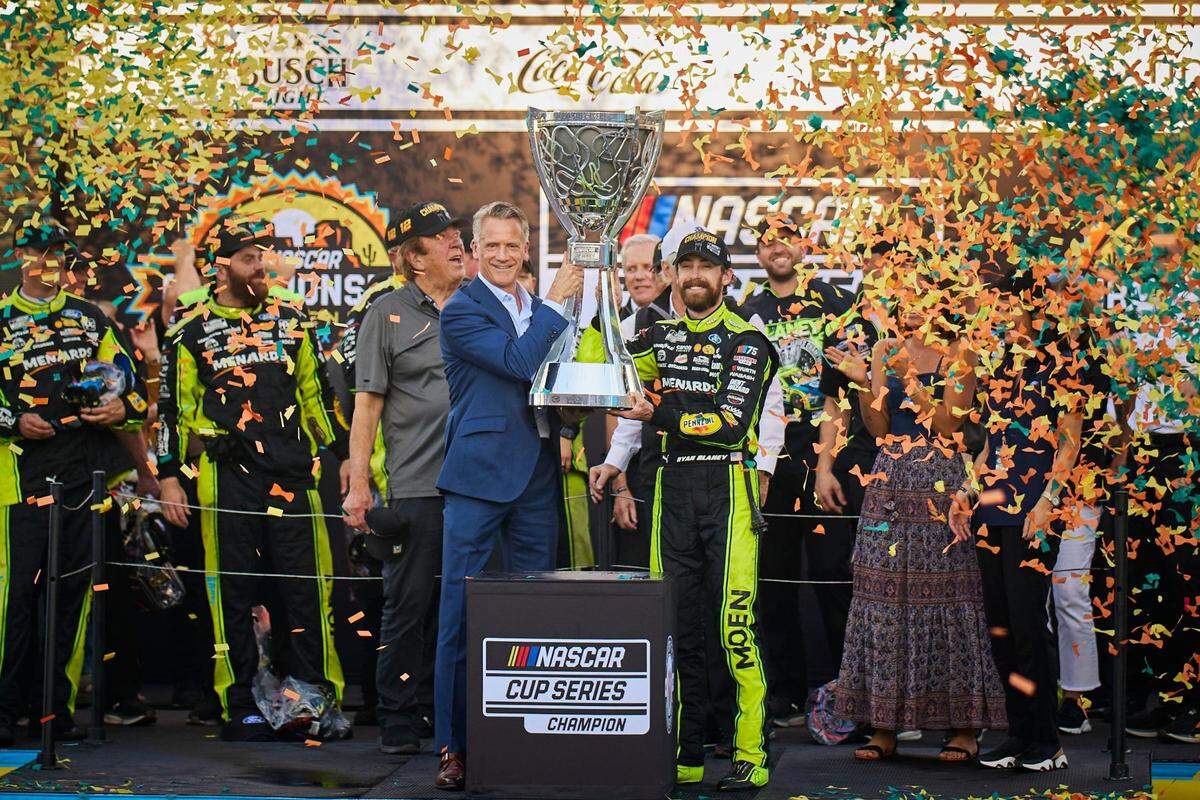 NASCAR Cup Series driver Ryan Blaney (12) hoists the Bill France Cup Championship Trophy with after the Cup Series Championship race at Phoenix Raceway in Avondale on Sunday, Nov. 5, 2023. Alex Gould/Special for The Republic