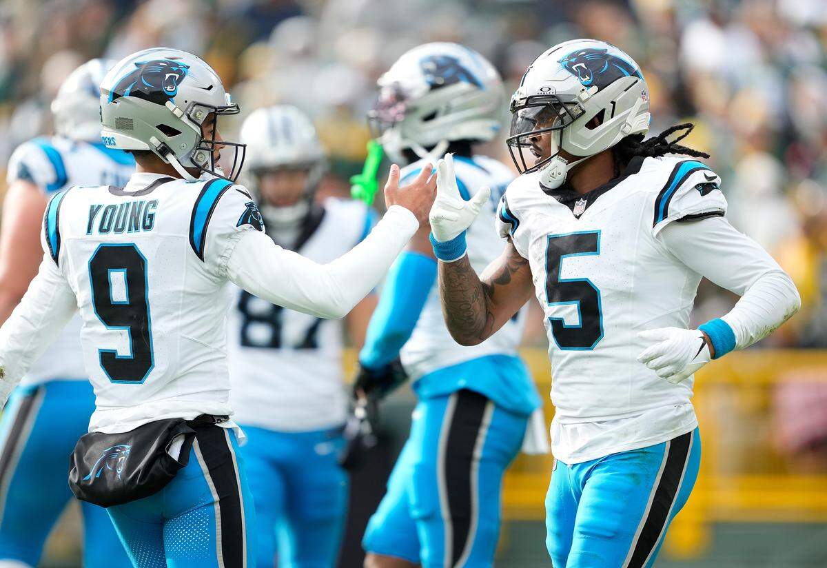 Bryce Young and Rico Dowdle (5) of the Carolina Panthers celebrate a touchdown in Sunday’s second quarter against the Green Bay Packers.
