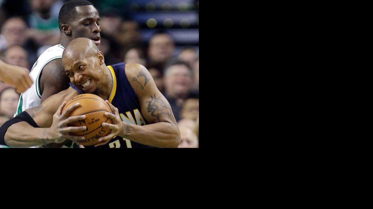 
Indiana Pacers forward David West (21) drives against Boston Celtics forward Brandon Bass during the first half of an NBA basketball game in Boston, Wednesday, April 1, 2015. 
