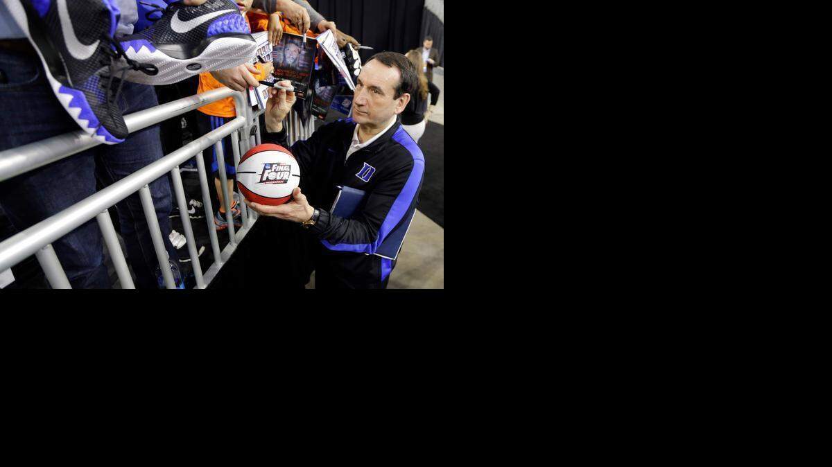 
Duke head coach Mike Krzyzewski signs autographs during a practice session for a college basketball regional semifinal game in the NCAA Tournament Thursday, March 26, 2015, in Houston. Duke plays Utah on Friday, March 27, 2015.
