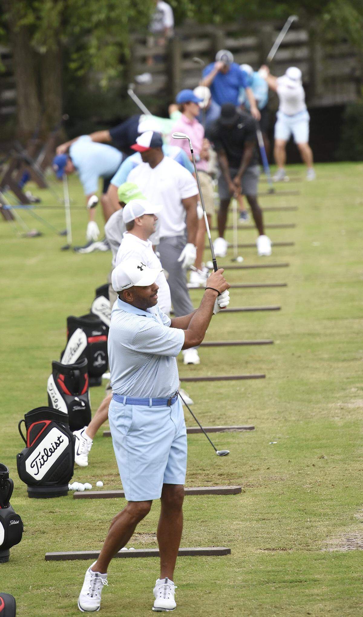 Dewll Curry and other athletes and celebrities warm up on the practice tee prior to the start of the Hooptee Celebrity Golf Classic .The 16th edition of the Hooptee Celebrity Golf Classic at Ballantyne Hotel & Lodge brought athletes, celebrities and others to raise money for a week long basketball camp. They hit the links Thursday, July 19, 2018.