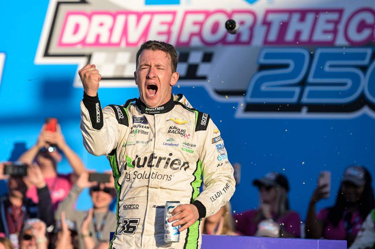 AJ Allmendinger celebrates in Victory Lane after winning the NASCAR Xfinity auto race at Charlotte Motor Speedway on Saturday, Oct. 8, 2022, in Concord, N.C. (AP Photo/Matt Kelley)