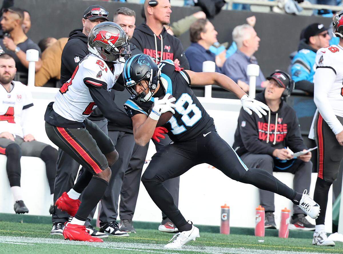 Tampa Bay Buccaneers Benjamin Morrison tries to stop Carolina Panthers Jalen Coker on Dec. 21, 2025, at Bank of America Stadium.