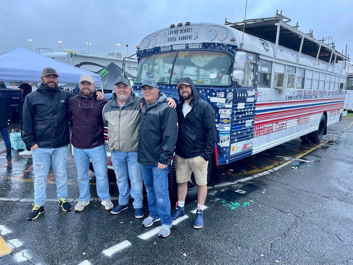 The family that runs the well-known school bus poses in the Charlotte Motor Speedway infield on Sunday, May 28, 2023. From left to right: Will Efaw, Brandon Efaw, Mike Efaw, Chris Efaw and Jeremy Efaw.