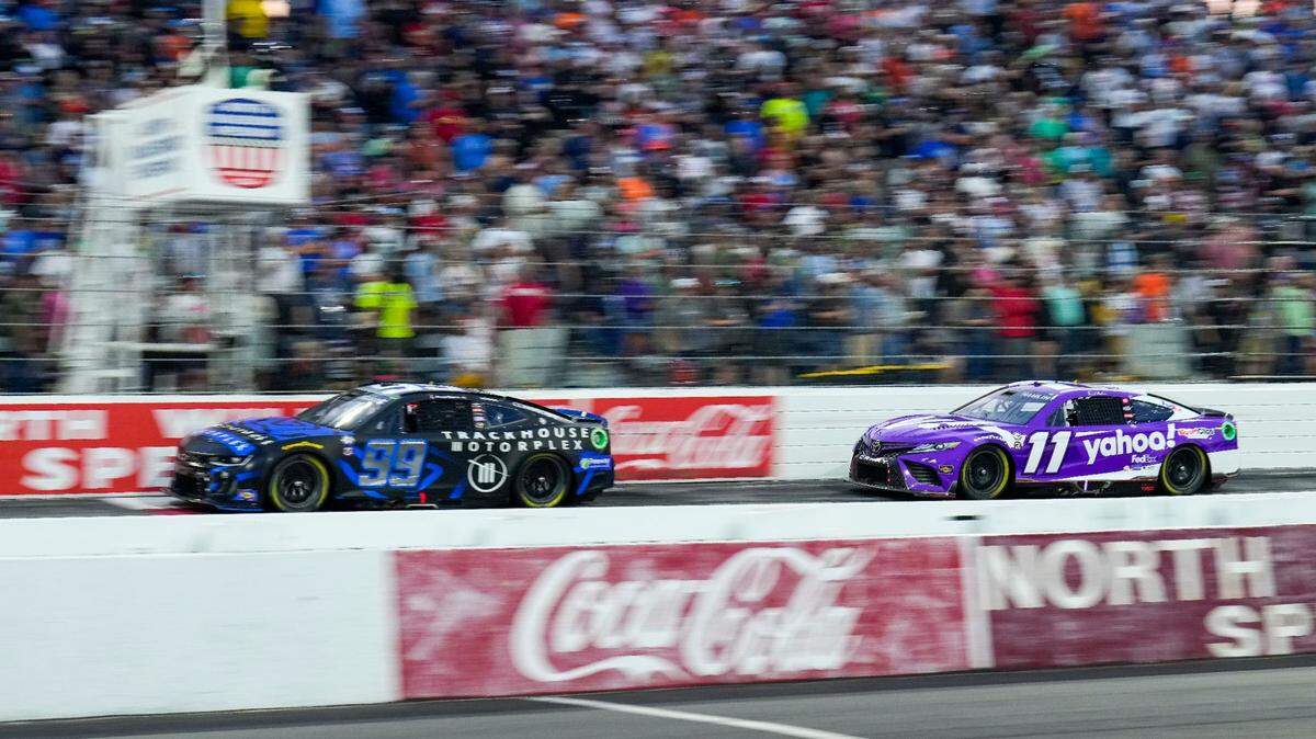 May 21, 2023; North Wilkesboro, North Carolina, USA; NASCAR Cup Series driver Daniel Suarez (99) and driver Denny Hamlin (11) race early on during the All Star Race at North Wilkesboro Speedway.